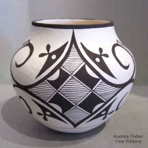 Medallion, rain and geometric design on a black and white jar