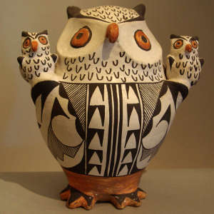 Two children on a polychrome owl effigy jar