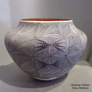 Fine line snowflake and geometric design on a polychrome jar