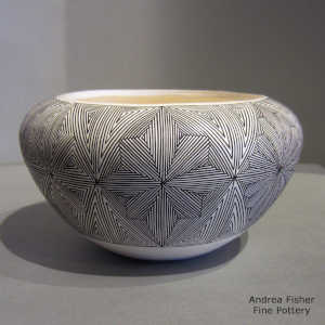 Snowflake fine line design on a black and white jar