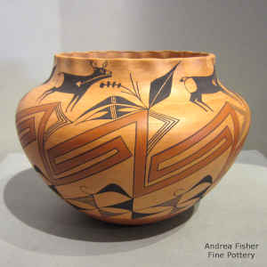 Deer, heart line and geometric design on a polychrome orange ware jar with a pie crust rim
