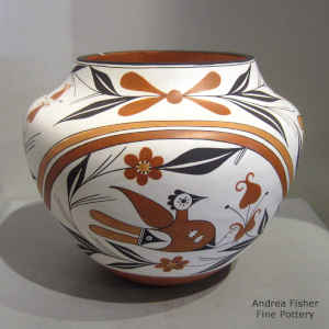 Bird, flower, rainbow and geometric design on a polychrome jar