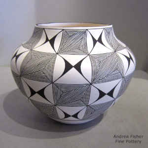 Fine line and geometric design on a black and white jar