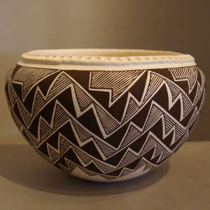 Lightning and rain design on a black and white jar with corrugated rim