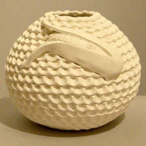 Raised ear of corn design on a white corrugated jar