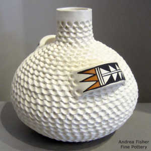 Polychrome handles with a geometric design on a corrugated white jar