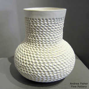 Corrugated surface on a tall necked white jar