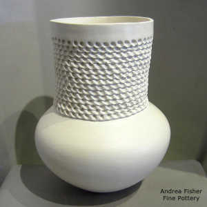 Corrugation around the neck of a tall neck white jar