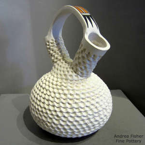 Geometric design painted on the handle of a corrugated white wedding vase