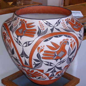Rainbow, parrot, floral and geometric designs on a large polychrome storage jar