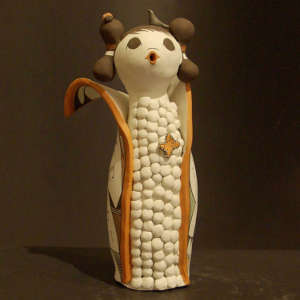 Butterfly, bird and ladybug on a polychrome corn maiden