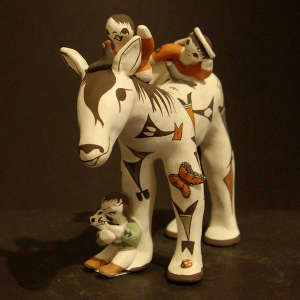 Three children, a bird, a puppy and a ladybug on a horse