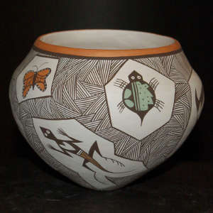 Animal and fine line design on a polychrome jar