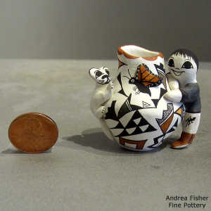 Child, cat, lady bug, butterfly and geometric design on a polychrome miniature pot