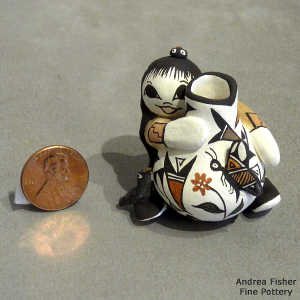 Girl, bird, lady bug and butterfly on a miniature polychrome jar