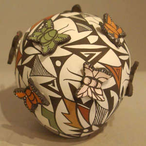 Raised butterflies and a geometric design on a polychrome seedpot