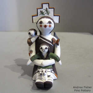 Two children, bird, cat butterfly and a tablita on a storyteller