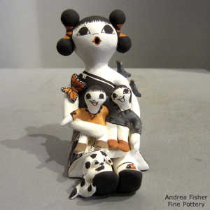 2 children, butterfly, birds, lady bug and a puppy on a storyteller