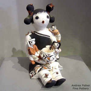 A geometric design on a grandmother storyteller with 3 children, birds, lady bugs, butterflies, a kitten, a pot and a geometric design