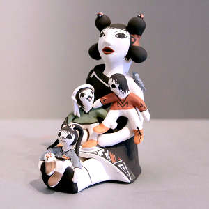 3 children on a storyteller figure