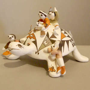 Four children on a turtle storyteller figure