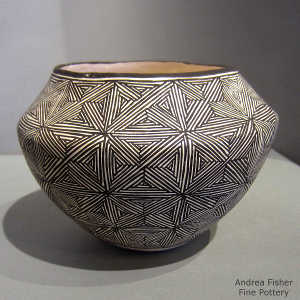 Snowflake fine line design on a black and white jar