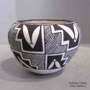 Fine line and geometric design on a black and white jar