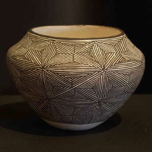 Fine line starburst design on a black and white jar