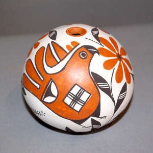 Parrot and flower design on a polychrome seed pot