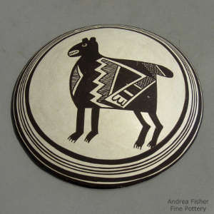 Animal and geometric design on a black and white hanging wall plate