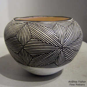 Fine line snowflake design on a black and white jar