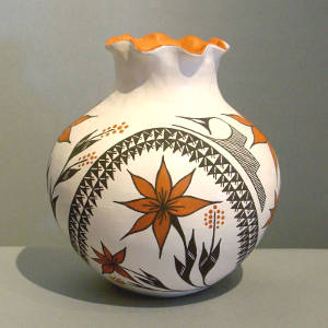 Flower and geometric design on a polychrome jar with a pie crust rim