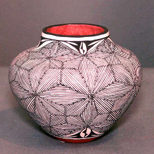 Fine line snowflake and geometric design on a polychrome jar