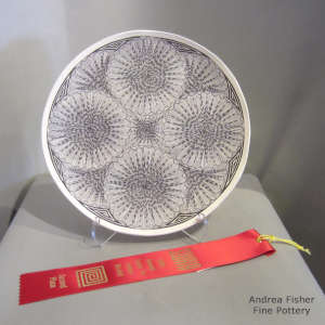 Fine line and geometric design on a polychrome jar