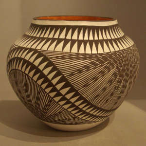 Black and white starburst and geometric design on a polychrome jar