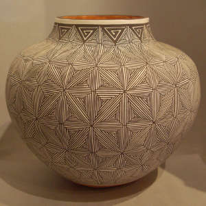Black and white fine line design on a polychrome jar