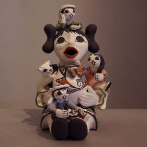 Three children, cat, turtle and butterfly on a female storyteller