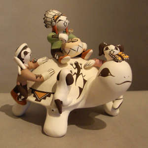 Three children, butterfly, lizard and puppy on a turtle storyteller