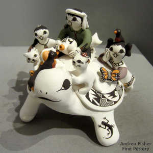 3 children, a puppy, kittens, birds, butterflies, lizards and a geometric design on a turtle storyteller figure