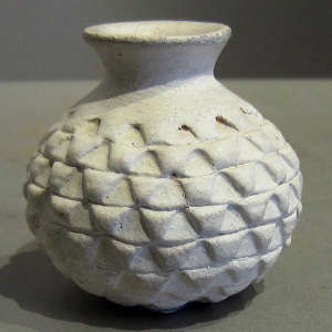 Miniature white jar with corrugated surface