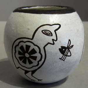 Bird and bee design on a black and white jar