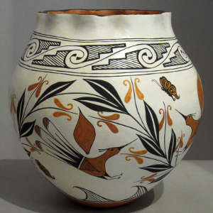 Birds, butterflies, floral and geometric designs on a polychrome jar with pie-crust rim