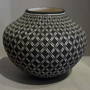 Traditional geometric design on a black and white jar