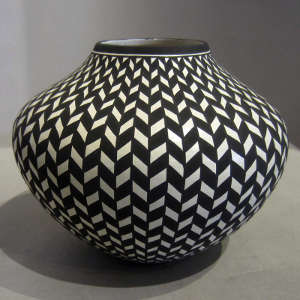 Traditional geometric design on a black and white jar