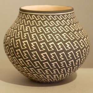 Bands of geometric design on a black and white jar