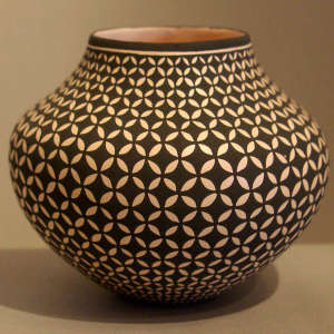 A snowflake geometric design on a black and white jar