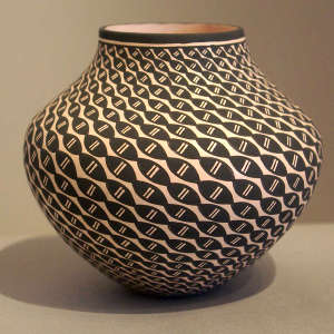 A spiral geometric design on a black and white jar