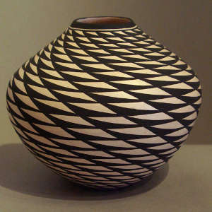 A spiral mesa geometric design on a black and white jar