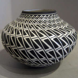 Interlocking geometric design on a black and white jar