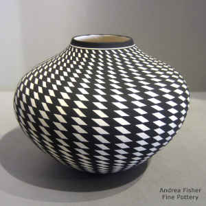 Spiral checkerboard geometric design on a black and white jar
